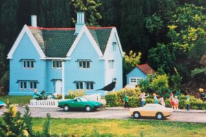 A model house within the Babbacombe model village, with a real blackbird on the lawn.